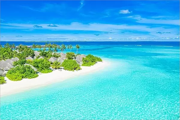 Aerial view of beach in Maldives luxury resort villas, bungalows. Seascape, paradise island landscape, tropical nature pattern. Amazing drone view