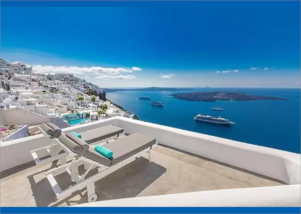 Santorini island, Greece. Travel and vacation concept, amazing summer view, white architecture blue sea view cruise ships. Lounge chairs luxury resort