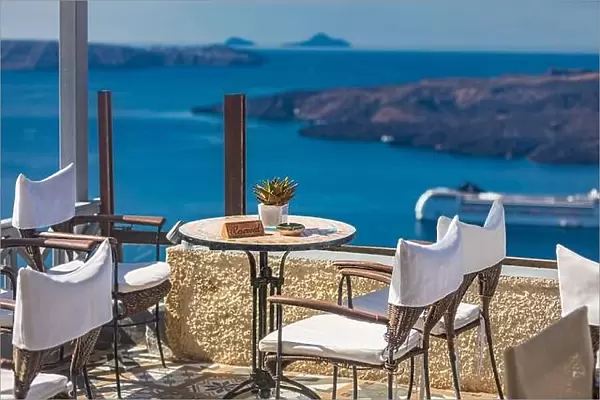 Beautiful terrace with sea view. Santorini island, Greece. Summer romantic travel restaurant on terrace with view on sea, Santorini island, Cyclades