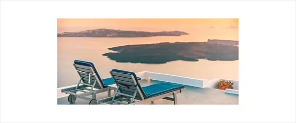Infinity pool on the rooftop at sunset in Santorini Island, Greece. Beautiful poolside and sunset sky. Luxurious summer vacation and holiday concept