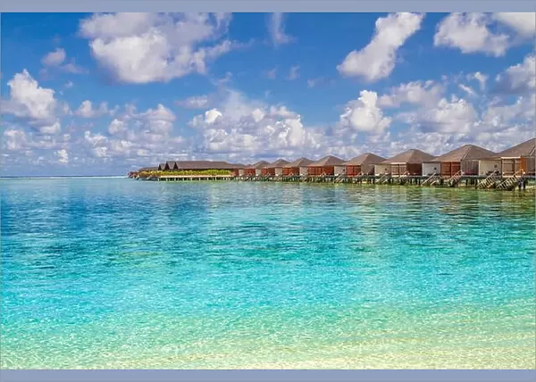 Luxury water bungalows and amazing blue sea in Maldives island. Paradise concept for summer vacation and holiday design