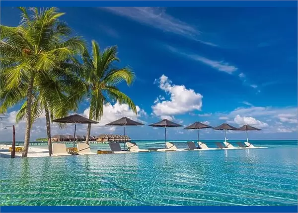 Summer luxury tourism landscape. Luxurious beach resort swimming pool reflection and beach chairs loungers, umbrellas palm trees blue sky poolside