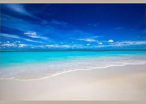 Beach and tropical sea. Stunning summer landscape, shore, coast with calm waves, relaxing seascape horizon over white sand blue sky. Tranquil nature
