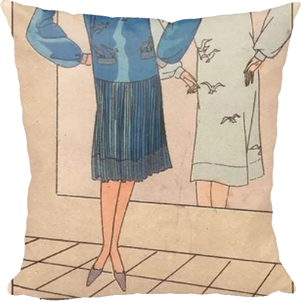 1920s woman in blue crepe dress embroidered with silver birds, pleated skirt, stading in front of a mirror