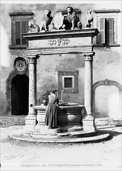 A woman at the well of the Piazza del Duomo in Montepulciano, Siena