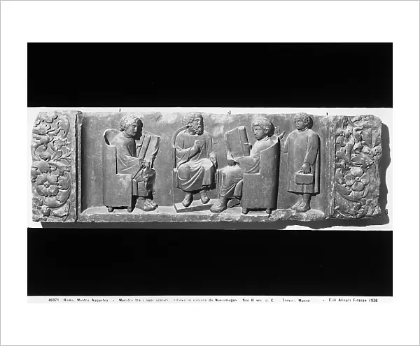 Master with scholars, limestone relief preserved in the Rheinisches Landesmuseum of Trier. The work was displayed at the Augustea Exhibit of Roman Culture held in Rome in 1937-1938