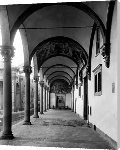 View of the Gallery of the Ospedale degli Innocenti, Florence. A door with a tympanum surmounted by a fresco is visible on the rear wall
