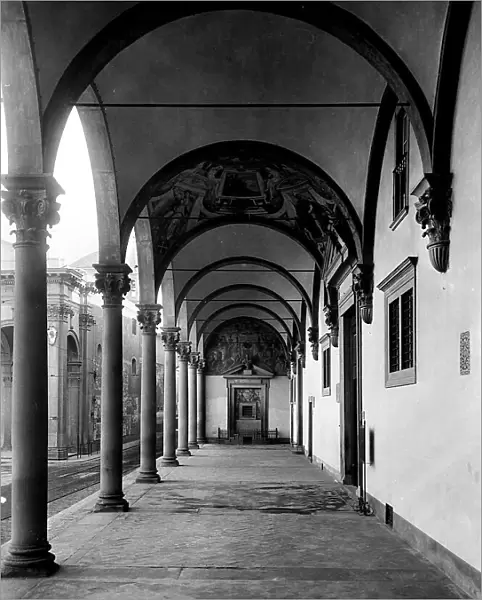 View of the Gallery of the Ospedale degli Innocenti, Florence. A door with a tympanum surmounted by a fresco is visible on the rear wall