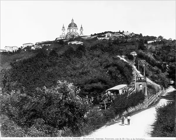 The cable-railway descends the Superga hill with passengers at the windows. In the background, the basilica of Superga