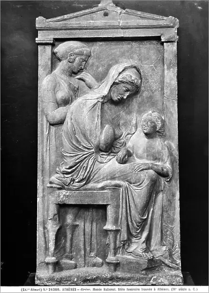 Funerary stele dedicated to a young woman portrayed with her son and a female servant. Work preserved in the National Museum of Athens