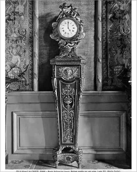 Clock mounted on a wooden base, from the age of Louis XVI, work preserved in the Louvre Museum, Paris