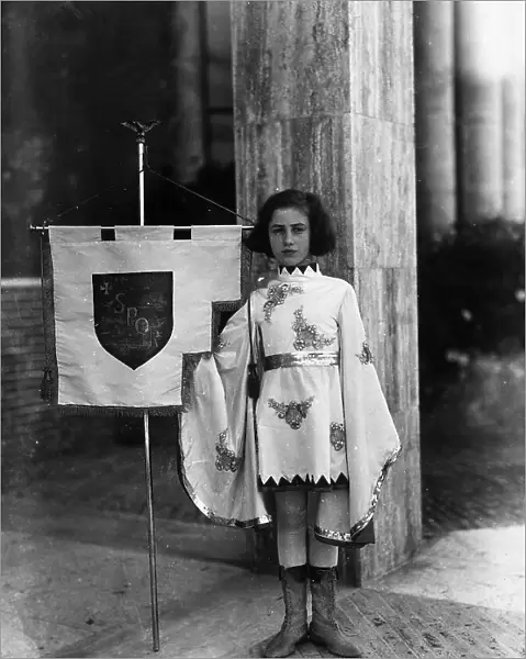 Villa Rosa Maltoni Mussolini: young girl dressed as a page boy with the banner of the city of Rome