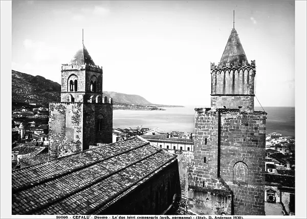 Rear view of the two bell towers of the Cathedral of Cefal, Sicily. The coast is in the background