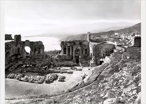 View of the ancient Greek Theatre of Taormina, with the cavea obtained from the natural cavity of a hill. In the distance, the gulf