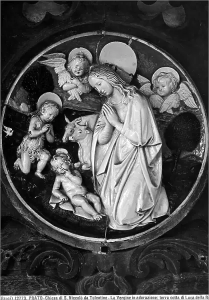 The Virgin and Young St. John adoring the Child. Terracotta high relief by Luca della Robbia located in the Church of S. Niccol da Bari in Prato