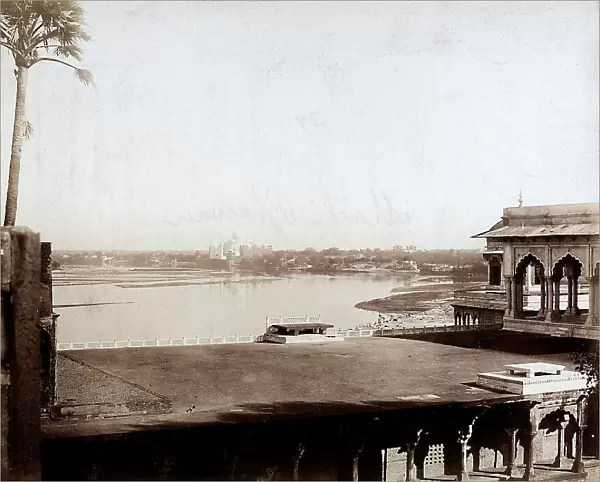 View of Agra, India. In the foreground, the buildings of the Machchi Bhavan (fishes palace). In the background, the il Taj Mahal can be seen