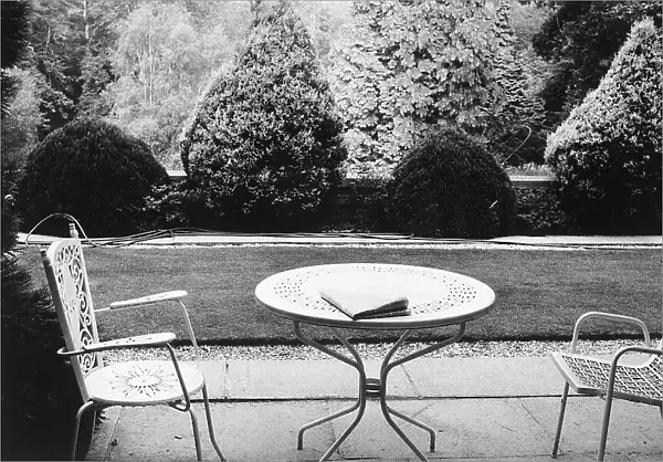 Table and chairs in a garden, in Surrey, Kent, in Great Britain