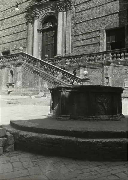 The portal and entrance stairway to the Church of San Domenico in Spoleto. In the foreground a well of XV cent