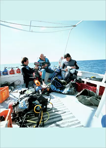 Folco Quilici between Luca and Andrea Tamagnini as they prepare for a dive to film and photograph underwater life in yhe so-called Secca di Levante (eastern shoal) off the Pelagian Islands, photographed by Anna Azan