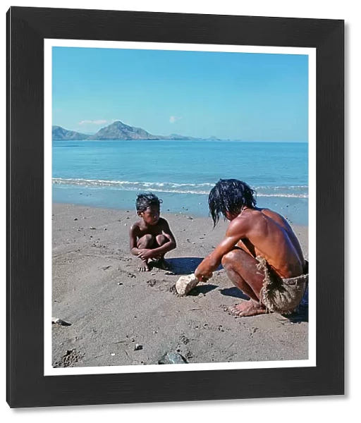 Sunda Islands, Flores Island, Father and son on a beach