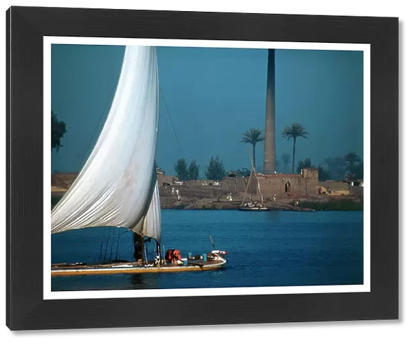 Cairo. The Nile River on the outskirts of the city in the industrial area, with a boat