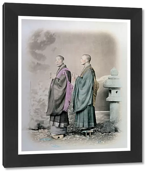 Full-length portrait, in profile, of two japanese priests of the Nitchi-Re-Shu sect. They are wearing long garments with full sleeves and high clogs. They are holding rosaries