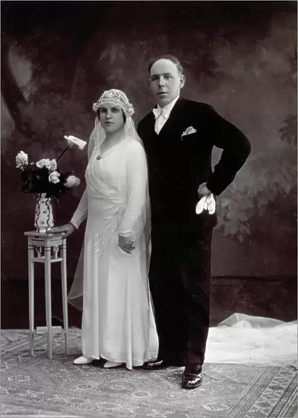 Full-length portrait of a bride and groom in their wedding clothes