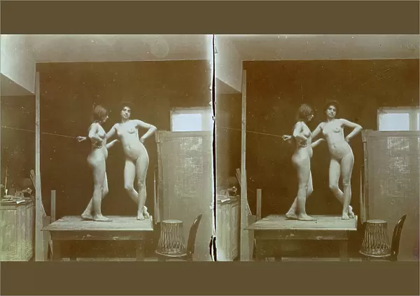 Two nude models, standing on a table, in the studio of the painter and photographer Michetti