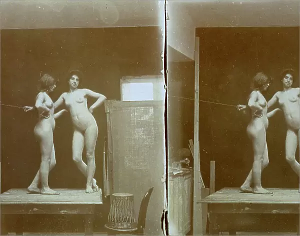 Two nude models, standing on a table, in the studio of the painter and photographer Michetti