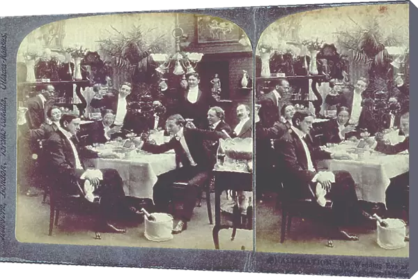 A group of bachelors in evening dress, around a laid table, they are making a toast, directed towards the man sitting at the head of the table in the foreground