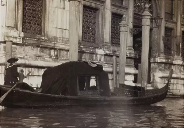 Gondola with gondolier in a canal in Venice