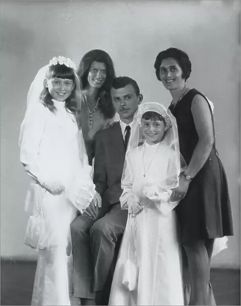 Family portrait with girls dressed for their first communion