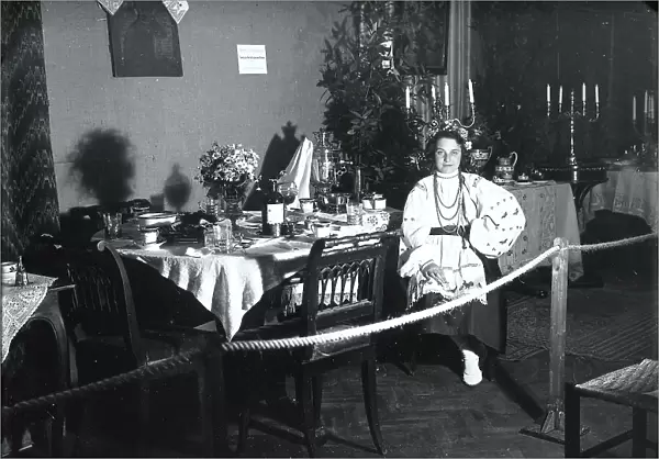 Table set up with a woman in a red outfit for the 'Tavole imbandite' display of the Industrie Femminili Italiane Anni Trenta, Trieste