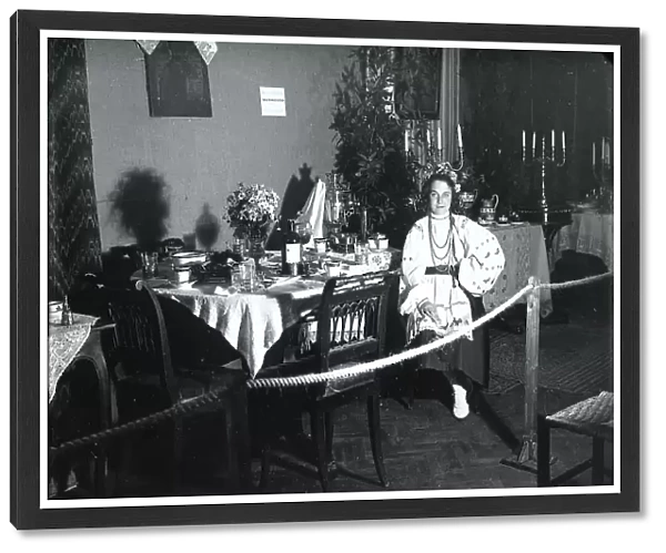 Table set up with a woman in a red outfit for the 'Tavole imbandite' display of the Industrie Femminili Italiane Anni Trenta, Trieste