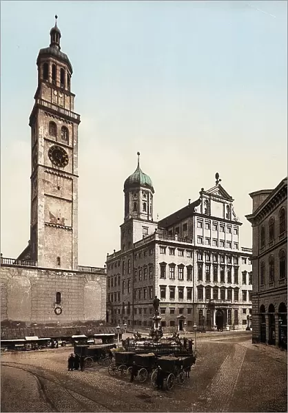 The Market Square, in Augsburg, Germany. At its centre, the fountain Augustusbrunnen rises, while the Romanesque tower called 'Perlachturm' and the other side of the Rathaus are visible in the background