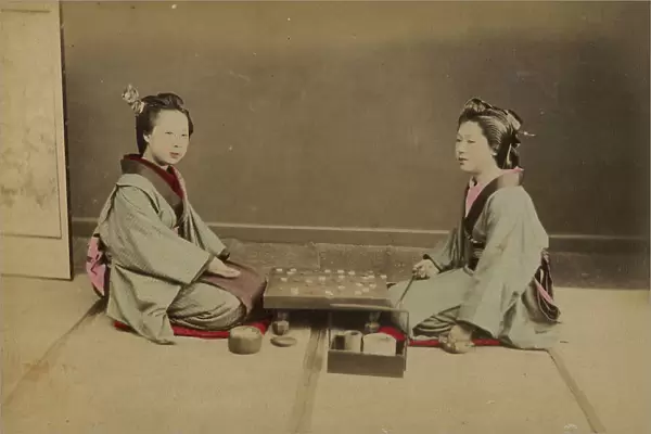 Two young Japanese women playing a game