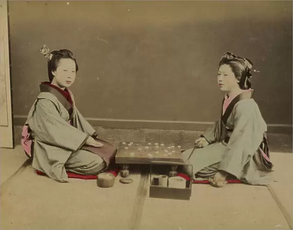 Two young Japanese women playing a game