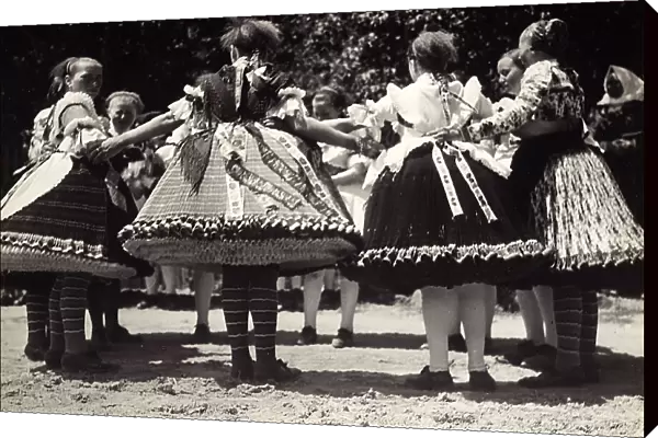 Traditional dance scene with ladies wearing Hungarian traditional dresses