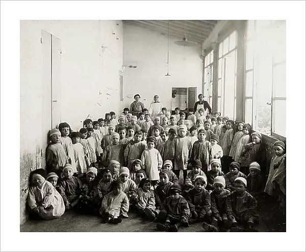 Children and instructors in a corridor of an orphanage