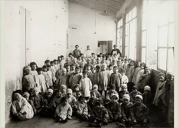 Children and instructors in a corridor of an orphanage