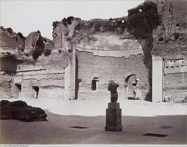 The gymnasium of the Caracalla Thermal Baths, Rome. A fragment of a statue is shown on a base