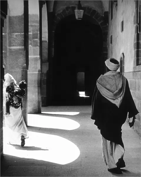 Moroccan man and woman under a portico