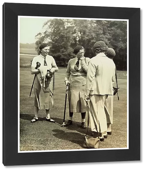 A group of women converse on a golf course