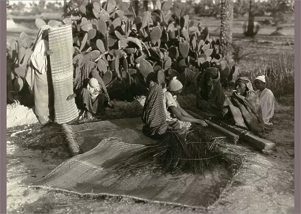 Natives converse seated on mats