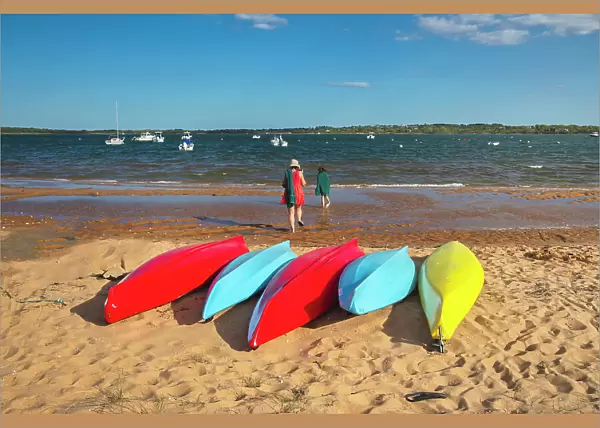 Massachusetts, Martha's Vineyard, Colorful Kayaks laying at Menemsha Pond Beach