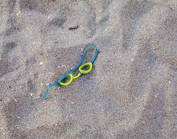 Swimming goggles on sand