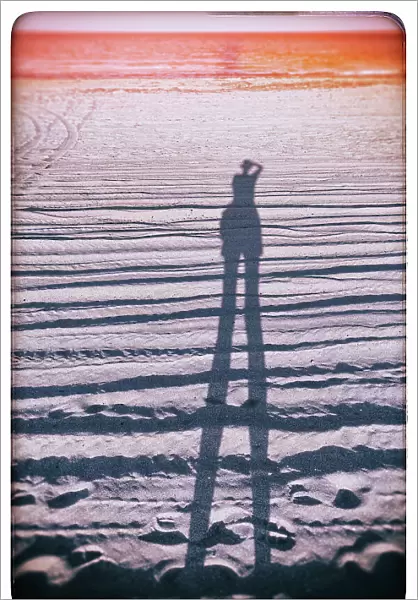 Abstract of figure taking a photo on the beach