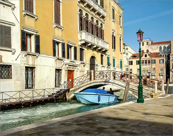 Italy, Veneto, Venice, Motor boat passing under bridge on canal