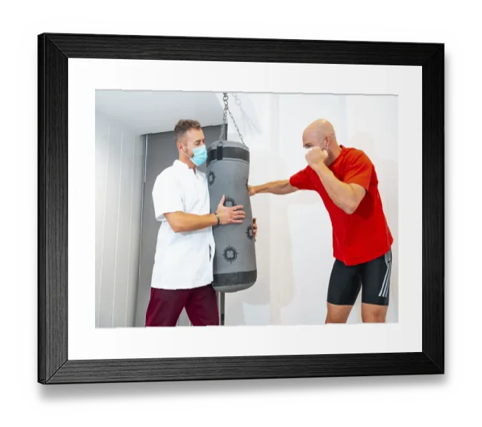 Framed Print : Physiotherapist and Patient on Punching Bag Print Framed Print : Physiotherapist and Patient on Punching Bag Print