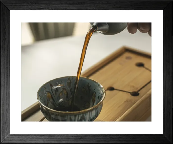 Framed Print : Fragrant Tea Pouring into Handcrafted Cup Print Framed Print : Fragrant Tea Pouring into Handcrafted Cup Print